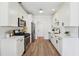 Modern kitchen with white cabinetry, stainless steel appliances, light countertops, and a clean, functional design at 4369 Milford Pl, Hoschton, GA 30548