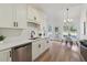 Bright eat-in kitchen features white cabinets, quartz countertops, stainless appliances, and sleek modern finishes at 4369 Milford Pl, Hoschton, GA 30548