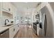 Contemporary kitchen with stainless steel appliances, bright white cabinets, and eat-in dining area at 4369 Milford Pl, Hoschton, GA 30548