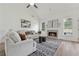 Bright living room with cozy fireplace, plush seating, neutral decor, and large windows offering ample natural light at 4369 Milford Pl, Hoschton, GA 30548