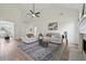 A bright living room displays stylish furniture, fireplace, and neutral decor, with an open layout to the dining area at 4369 Milford Pl, Hoschton, GA 30548
