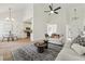 A cozy living room with stylish decor, offering an open view to the dining area and entry at 4369 Milford Pl, Hoschton, GA 30548