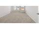 Large bedroom with neutral carpeting, white walls, and abundant natural light at 4451 Manor Hill Dr, Union City, GA 30291