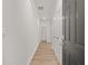 Bright hallway with wood-look flooring and white trim, leading to additional rooms at 4451 Manor Hill Dr, Union City, GA 30291