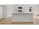 Bright kitchen featuring a center island with stainless steel sink and white cabinets at 4451 Manor Hill Dr, Union City, GA 30291