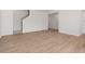 Bright living room featuring hardwood floors, white walls, and stairway access at 4451 Manor Hill Dr, Union City, GA 30291