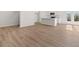 Open-concept living area featuring hardwood floors and a bright kitchen with white cabinets at 4451 Manor Hill Dr, Union City, GA 30291