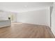 Open-concept living space with wood-look floors and sliding doors to the backyard at 4451 Manor Hill Dr, Union City, GA 30291