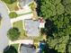 Stunning aerial shot of a beautiful home with a spacious deck and a vibrant red umbrella, surrounded by lush trees at 1630 Reindeer Rdg, Alpharetta, GA 30005