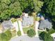 Beautiful aerial view of a home with a pool and lush landscaping surrounded by trees at 1630 Reindeer Rdg, Alpharetta, GA 30005