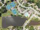 Aerial view featuring a serene lake, community pool, tennis courts and lush green landscaping at 1630 Reindeer Rdg, Alpharetta, GA 30005