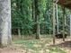 Tranquil backyard setting with mature trees, and a classic picket fence for added privacy and charm at 1630 Reindeer Rdg, Alpharetta, GA 30005