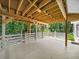 Large outdoor deck area with wood beams, overlooks wooded lot, offering outdoor space for relaxing or entertaining at 1630 Reindeer Rdg, Alpharetta, GA 30005