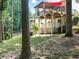 Lovely two-story home showcasing a backyard deck and patio with a red umbrella, surrounded by trees and greenery at 1630 Reindeer Rdg, Alpharetta, GA 30005