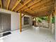 Back porch with access to a wooded yard provides an outdoor living space for relaxation and entertaining at 1630 Reindeer Rdg, Alpharetta, GA 30005