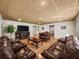 Basement with a large dark leather sectional, and a large tv at 1630 Reindeer Rdg, Alpharetta, GA 30005