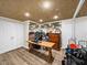 Finished basement space with wood-look floors, recessed lighting, and mirrored wall, suitable for recreation at 1630 Reindeer Rdg, Alpharetta, GA 30005
