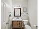 Powder room with wooden vanity, modern mirror, and tiled floors at 1630 Reindeer Rdg, Alpharetta, GA 30005