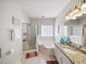 Bright bathroom featuring shower, tub, granite counters, dual sinks, and a vanity at 1630 Reindeer Rdg, Alpharetta, GA 30005