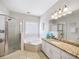 Bright bathroom featuring shower, tub, granite counters, sink, and a vanity at 1630 Reindeer Rdg, Alpharetta, GA 30005