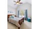 Light-filled bedroom with vaulted ceiling, ceiling fan, window, and decor at 1630 Reindeer Rdg, Alpharetta, GA 30005