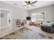 Bright bonus room with a ceiling fan, natural light, neutral carpet, and comfortable seating at 1630 Reindeer Rdg, Alpharetta, GA 30005