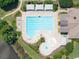 Aerial view of a community pool, featuring multiple shaded areas, lounge chairs, and a fun splash pad for  at 1630 Reindeer Rdg, Alpharetta, GA 30005