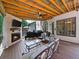 Back deck with fireplace and outdoor grill, perfect for entertaining and relaxation in a natural setting at 1630 Reindeer Rdg, Alpharetta, GA 30005