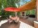 Outdoor deck with fireplace and seating area for enjoying outdoor gatherings and relaxation in wooded back yard at 1630 Reindeer Rdg, Alpharetta, GA 30005