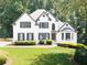 Charming two-story home with a well-manicured lawn and lush landscaping at 1630 Reindeer Rdg, Alpharetta, GA 30005