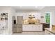 Bright kitchen with stainless steel appliances, white cabinets, and tile flooring at 1630 Reindeer Rdg, Alpharetta, GA 30005