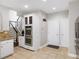 Kitchen showcasing stainless steel double ovens, white cabinets, and tile floor at 1630 Reindeer Rdg, Alpharetta, GA 30005