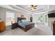 Main bedroom featuring tray ceiling, neutral carpet, and large windows at 1630 Reindeer Rdg, Alpharetta, GA 30005