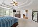 Spacious main bedroom with a tray ceiling, carpeted floor, and many windows at 1630 Reindeer Rdg, Alpharetta, GA 30005