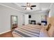 Spacious bedroom featuring tray ceilings, wood floors, and ample natural light at 5990 Eagle Tiff Ln, Sugar Hill, GA 30518