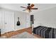 Bedroom showcasing a ceiling fan, a plush rug, and a guitar hanging on the wall at 5990 Eagle Tiff Ln, Sugar Hill, GA 30518