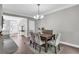 Charming dining room with a rustic wooden table, elegant chairs, and a view of the front entrance at 5990 Eagle Tiff Ln, Sugar Hill, GA 30518