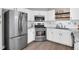 Well-lit kitchen with stainless steel appliances and sleek, modern cabinetry at 5990 Eagle Tiff Ln, Sugar Hill, GA 30518