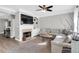 Cozy living room with a fireplace, built-in shelving, and comfortable seating, perfect for relaxation at 5990 Eagle Tiff Ln, Sugar Hill, GA 30518