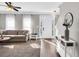 Open-concept living room with a stylish sofa, modern decor, and plenty of natural light at 5990 Eagle Tiff Ln, Sugar Hill, GA 30518
