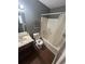 Cozy bathroom features a vanity with a sink and a shower/tub combo with storage rack at 6470 Bedford Ln, Lithonia, GA 30058