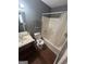 Bathroom with a sink and bathtub with a showerhead and wood look flooring at 6470 Bedford Ln, Lithonia, GA 30058