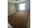 An empty bedroom with carpeted floor, neutral walls and natural light at 6470 Bedford Ln, Lithonia, GA 30058