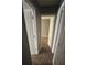 Hallway with a view of a bedroom with neutral colored walls and flooring at 6470 Bedford Ln, Lithonia, GA 30058