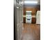 Kitchen featuring wood cabinets, laminate countertops, white appliances, and wood look flooring at 6470 Bedford Ln, Lithonia, GA 30058