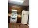 Kitchen featuring wood cabinets, laminate countertops, white appliances, and wood look flooring at 6470 Bedford Ln, Lithonia, GA 30058