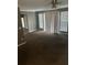 Neutral living room featuring a ceiling fan, neutral carpet and bright windows at 6470 Bedford Ln, Lithonia, GA 30058