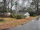 A charming house sits on a tree-lined street, blending into the neighborhood at 1088 Palafox Ne Dr, Atlanta, GA 30324