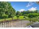 Beautiful backyard view from the balcony, showcasing the expansive lawn, trees, and surrounding landscape at 226 Euharlee Five Forks Rd, Kingston, GA 30145