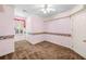 Carpeted bedroom featuring pink walls, white trim, a ceiling fan, and decorative border at 226 Euharlee Five Forks Rd, Kingston, GA 30145